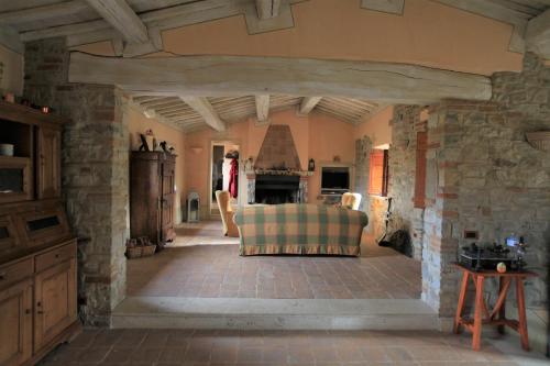 a living room with a couch and a fireplace at Antico Gelso in Todi