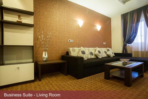 a living room with a couch and a table at INTER BUSINESS Bucharest in Bucharest