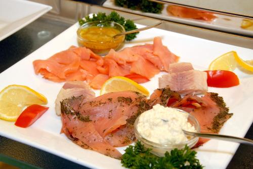 a plate of food with fish and other foods at Hotel Karl in Offenbach