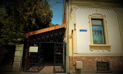 an entrance to a building with an open gate at Charlietown in Satu Mare