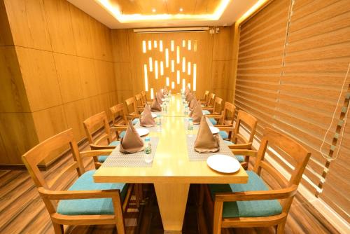 a long dining room with a long table and chairs at SureStay Plus by Best Western Amritsar in Amritsar