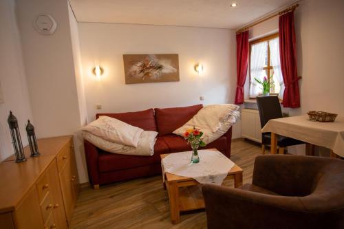 a living room with a couch and a table at Haus Thanner - Chiemgau Karte in Inzell