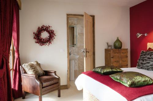 a bedroom with a bed and a chair and a wreath at Black Diamond Sainte Foy Chalets in Sainte-Foy-Tarentaise