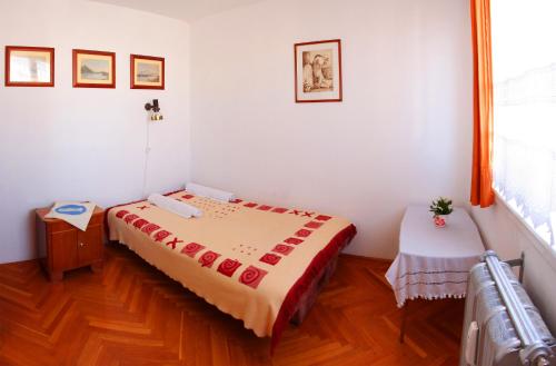 a small bedroom with a bed and a table at Óbuda Apartments in Budapest