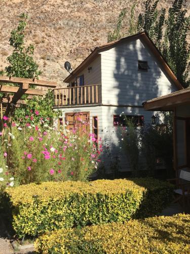 a house with a bunch of flowers in front of it at Hotel Faro del Valle in Pisco Elqui
