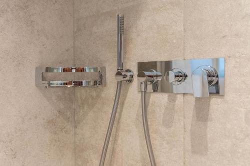 a shower with two shower heads in a bathroom at Apartment Justine Wurdengeja in Selva di Val Gardena
