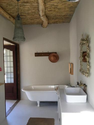 a bath tub and a sink in a bathroom at The Olive House, Prince Albert in Prince Albert