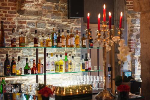 a bar with a lot of bottles of alcohol at Van Der Valk Sélys Liège Hotel & Spa in Liège