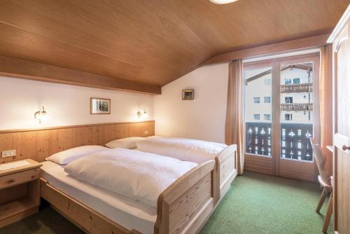 Postel nebo postele na pokoji v ubytování Panoramico Haus Forelle