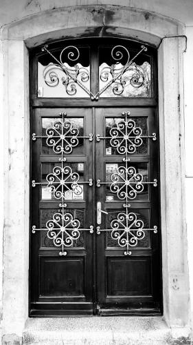 a large door to a building with wrought iron at Penzion Na Figleně in Slatinice