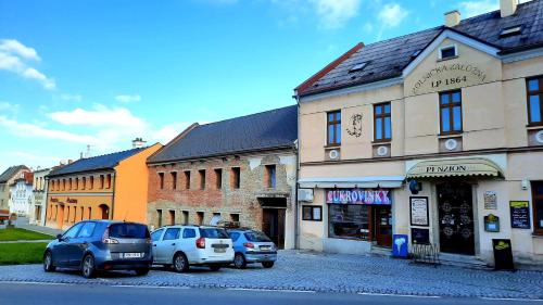 a group of cars parked in front of a building at Penzion Na Figleně in Slatinice