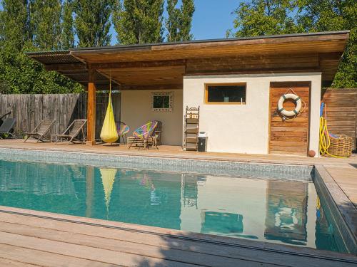 a house with a swimming pool in front of it at Montjoia in LʼIsle-sur-la-Sorgue