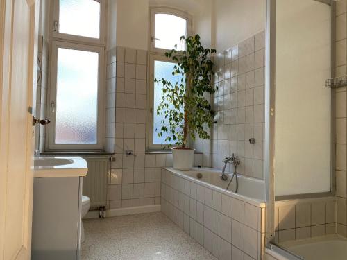 a bathroom with a tub and a toilet and a sink at Ferienwohnungen Neumann in Bamberg
