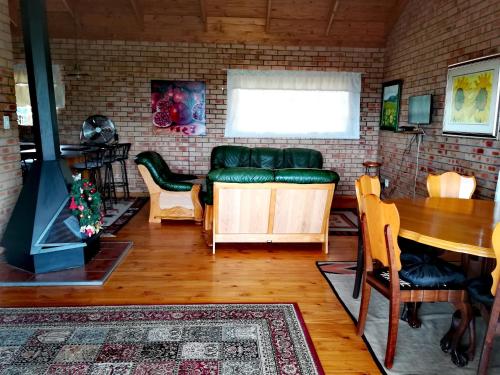 a living room filled with furniture and a fire place at Clarens Eddies Guest house in Clarens