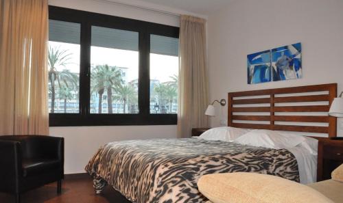 a bedroom with a bed and a large window at La Ciudadela in Barcelona