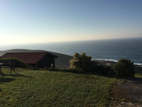 a house on a hill next to the ocean at Bungalow 1 - Playa Arnela in Carballo