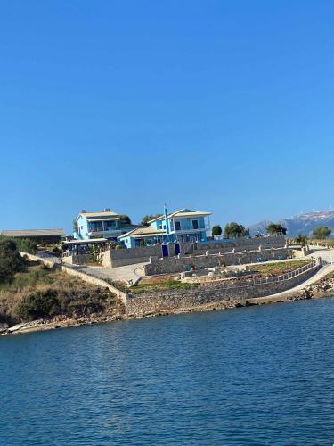 a group of houses on the shore of a body of water at Iris Villas in Spárton