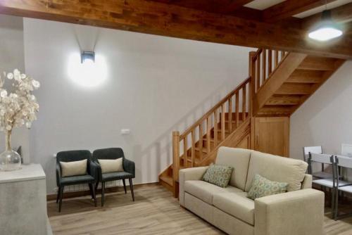a living room with a couch and two chairs at Apartamentos La Ventana de Mogrovejo in Mogrovejo