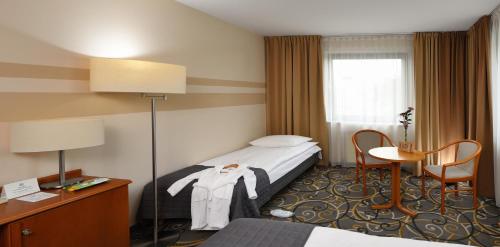 Postel nebo postele na pokoji v ubytování City Hotel