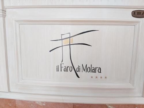 a sign with the name of mocha on a wall at Hotel il Faro di Molara in Porto San Paolo