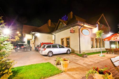 a car parked in front of a house at night at Hotel Zalesie in Bochnia