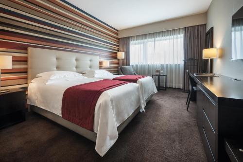 A bed or beds in a room at Hotel Trópico