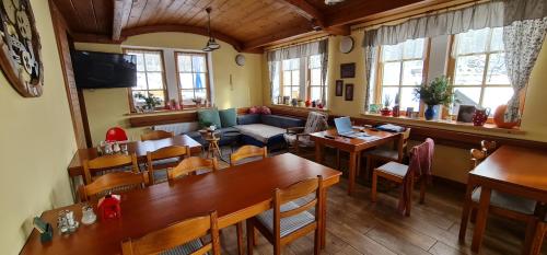 a living room with tables and a couch at hotel ZLATÝ POTOK in Nicov