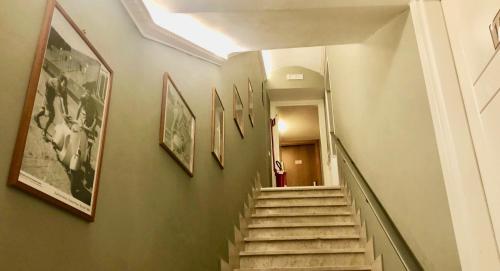 a hallway with stairs and pictures on the wall at Navona Residenza de Charme in Rome