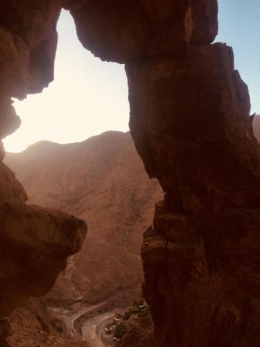 a view of a canyon from a cave in the desert at Auberge Le Festival Todra Gorge in Aït Baha