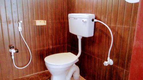 a bathroom with a toilet and a shower at Mermaid Island Beach Resorts in Puducherry