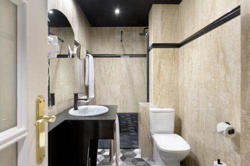 a bathroom with a sink and a toilet at Hotel Inca in Zaragoza