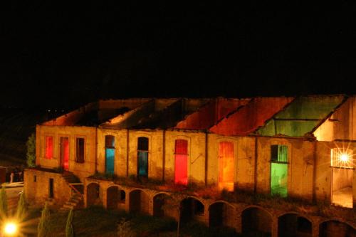 an old building with colorful doors at night at Masseria Sant'Agapito in Lucera