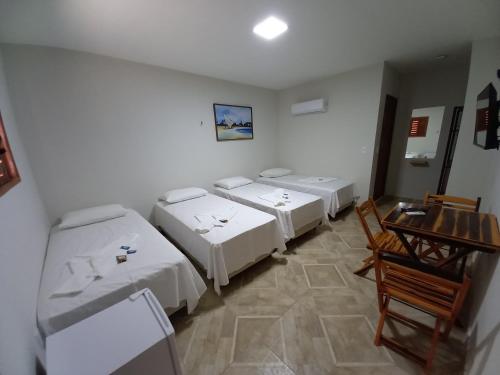 Una cama o camas en una habitación de Pousada Mar de Miroca
