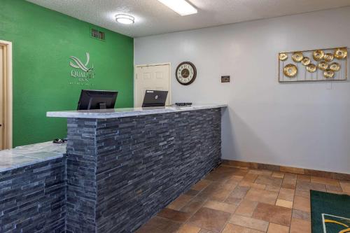 a lobby with a stone counter and a green wall at Quality Inn Kirksville in Kirksville