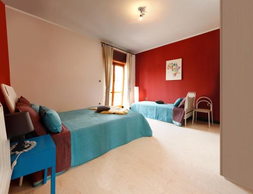 a bedroom with two beds and red walls at B&B Business in Casalnuovo di Napoli