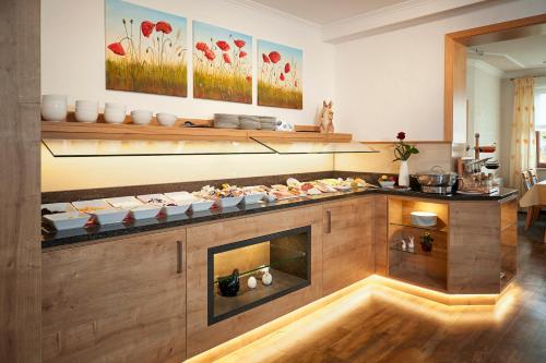 a kitchen with a counter with food on it at Hotel & Ferienappartements Edelweiss in Willingen