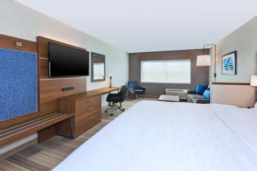 a hotel room with a bed and a flat screen tv at Holiday Inn Express- Eau Claire West I-94, an IHG Hotel in Eau Claire