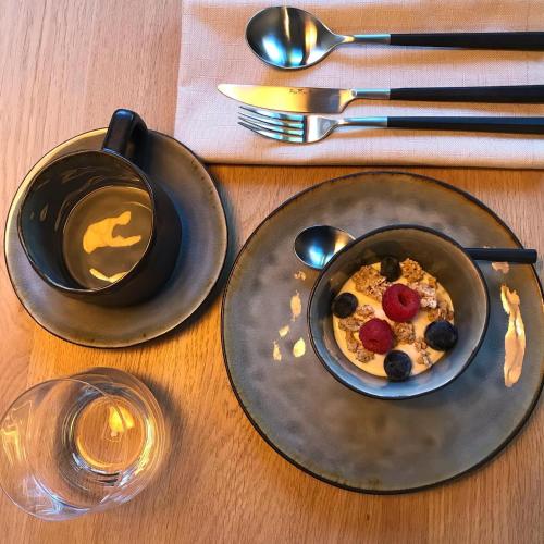 a plate of food on a table with a bowl of food at B&B Villa Mimosa in Pelt