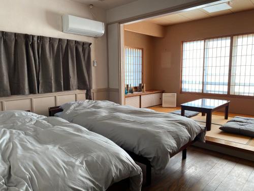 Ліжко або ліжка в номері Iroriyado Gen