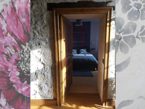 a door leading into a bedroom with a bed at chambres d'hôtes du Tilleul in Nanteuil-en-Vallée
