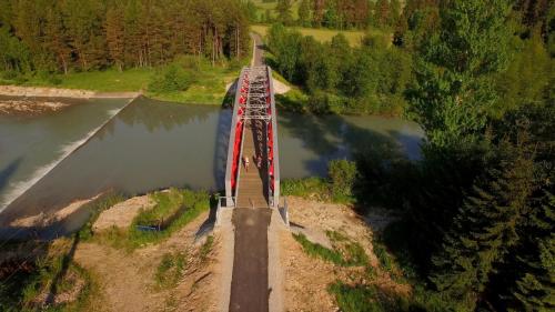 a train crossing a bridge over a river at Apartament Rodzinny in Nowy Targ