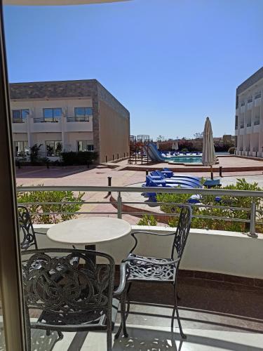 a patio with a table and chairs on a balcony at 2nd Cecilia beach resort studio in Hurghada