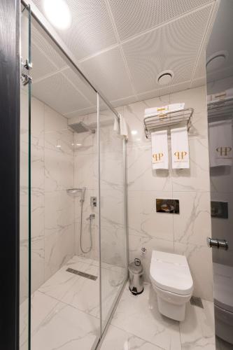 a white bathroom with a toilet and a shower at Ferman Port Hotel - Special Category in Istanbul