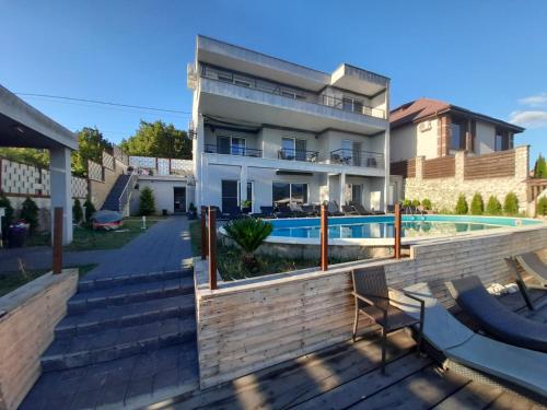 uma casa com piscina ao lado de um edifício em New Exclusive em Eşelniţa