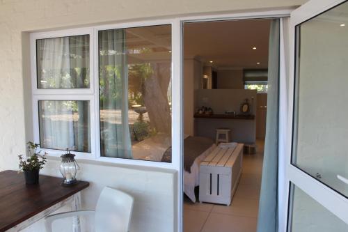 a room with a sliding glass door with a living room at Nuwerus Lodge Paarl in Paarl