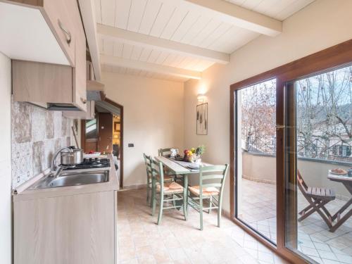 a kitchen with a sink and a table with chairs at Appartamenti Villa Tonni in Gabicce Mare