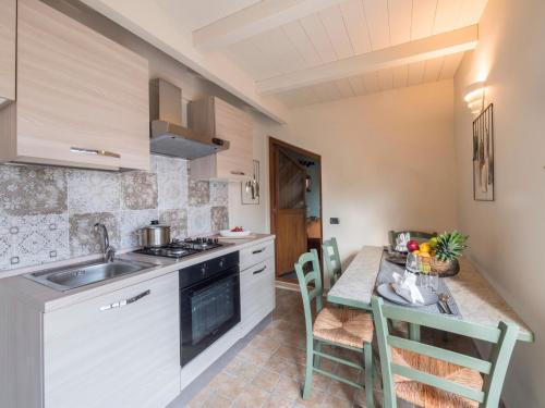 a kitchen with a sink and a table with chairs at Appartamenti Villa Tonni in Gabicce Mare