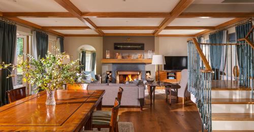 a living room with a table and a fireplace at Sheen Falls Lodge in Kenmare