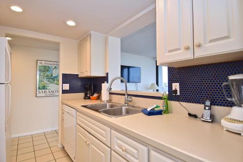 a kitchen with a sink and a refrigerator at Our House at the Beach 501W in Siesta Key