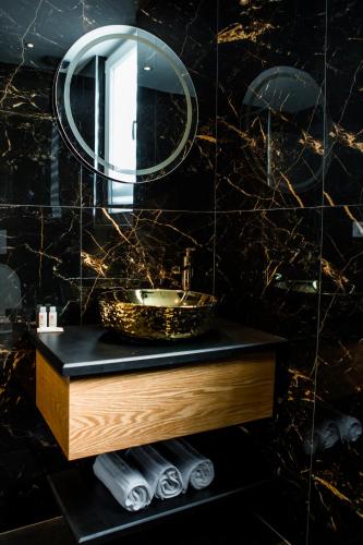 a bathroom with a sink and a mirror at Hotel Bonsai in Tirana